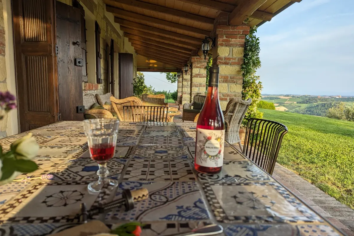 A table laid on the Tenuta Magrini terrace, looking over the vineyards
